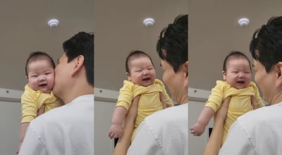 Shooting star receives a kiss from father Jay and smiles with a heart attack