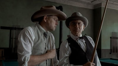 In the movie 'Flower Killing Moon', what's behind the DiCaprio scene that suits De Niro?