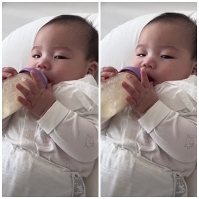'Hong Hyeon-hee's little star, chubby fingers holding a baby formula bottle